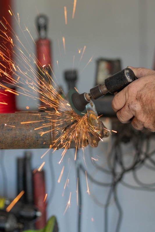 Angle grinder sparks on pipe