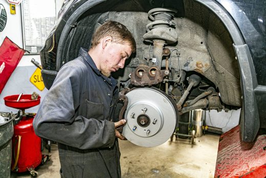 Mechanic holding a new brake rotor