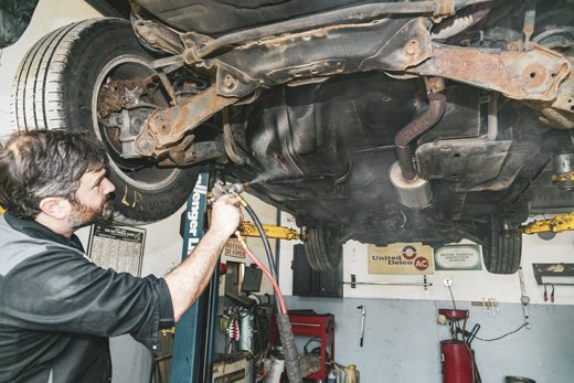 Spraying rust undercoating on the underbody