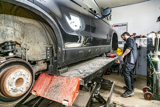 SUV up on the lift with a wheel off for a multi-point inspection at Auto Solve