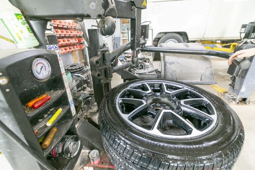 Tire being mounted onto an alloy wheel on the tire machine at Auto Solve