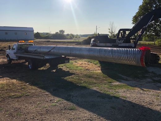 Auto Solve flatbed hauling a large culvert pipe